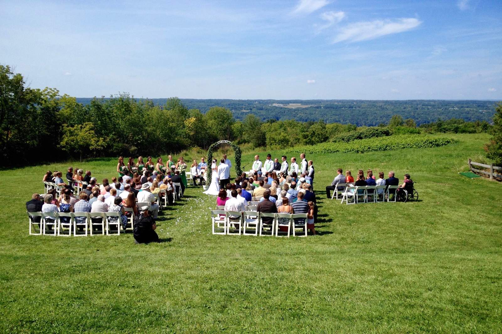 An outdoor ceremony on a hilltop lawn