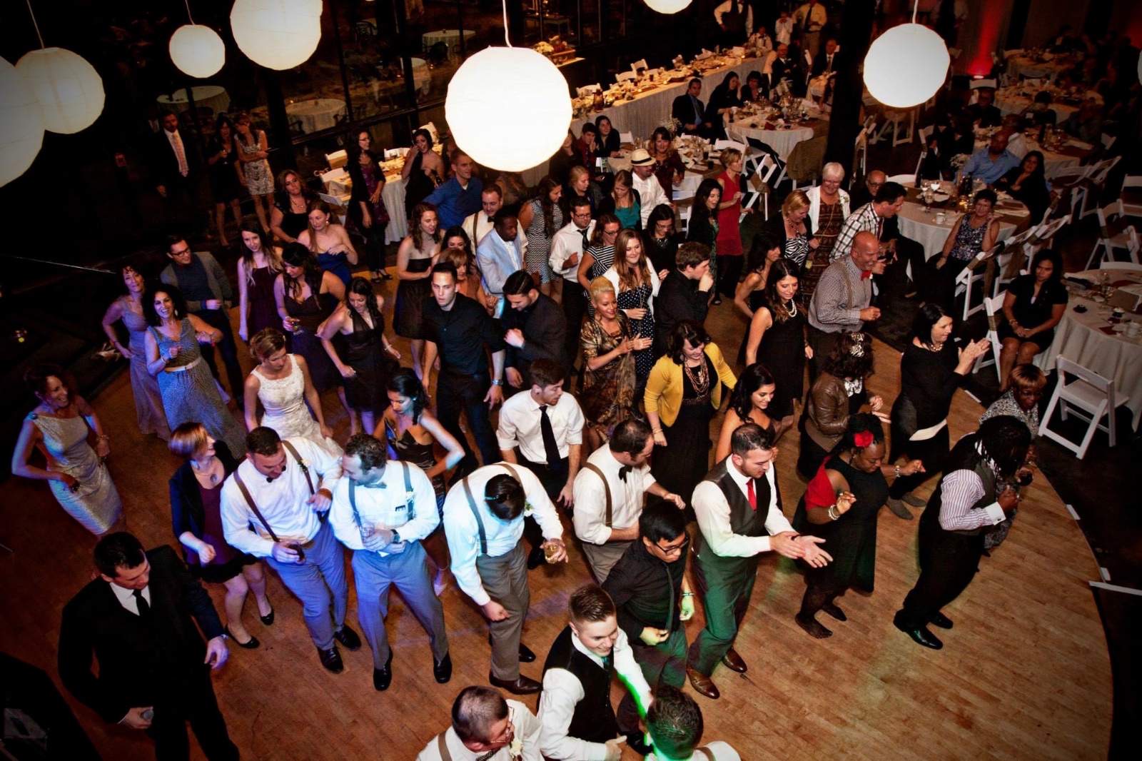 Guests dancing under white lanterns