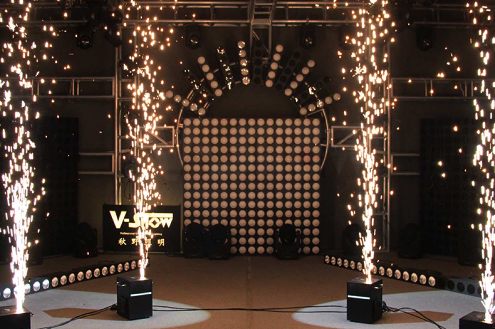 Indoor sparkler fountains framing an LED DJ booth