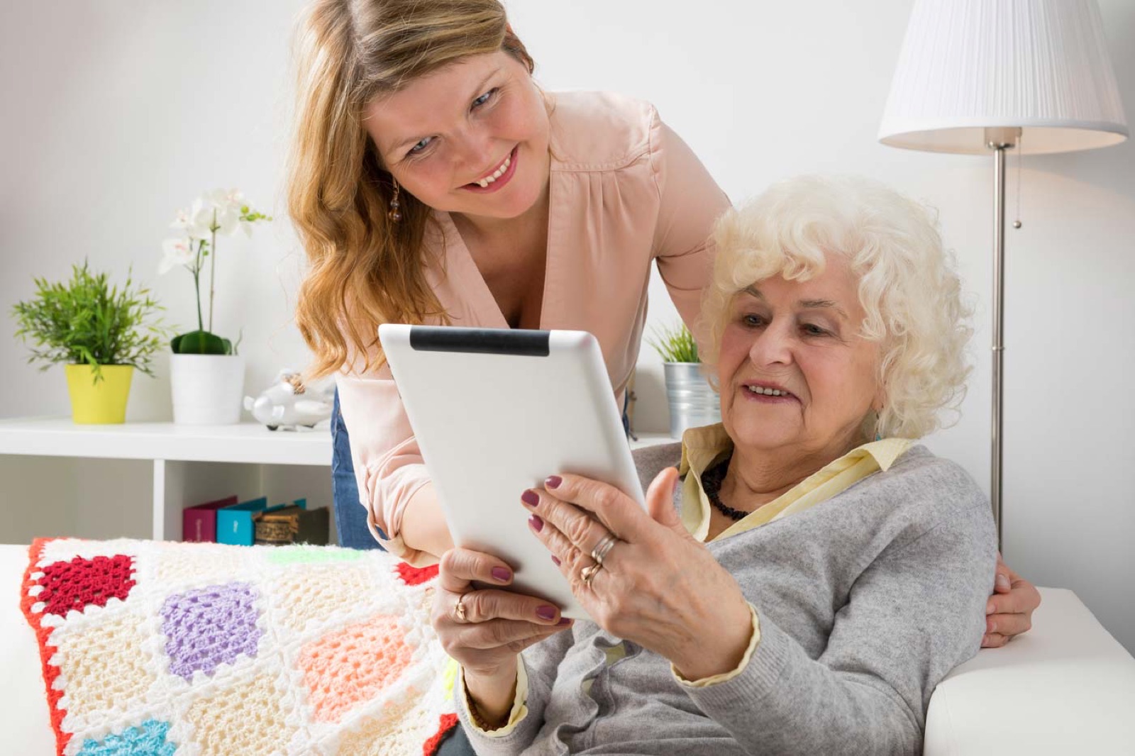 A grandmother watching the wedding on a tablet